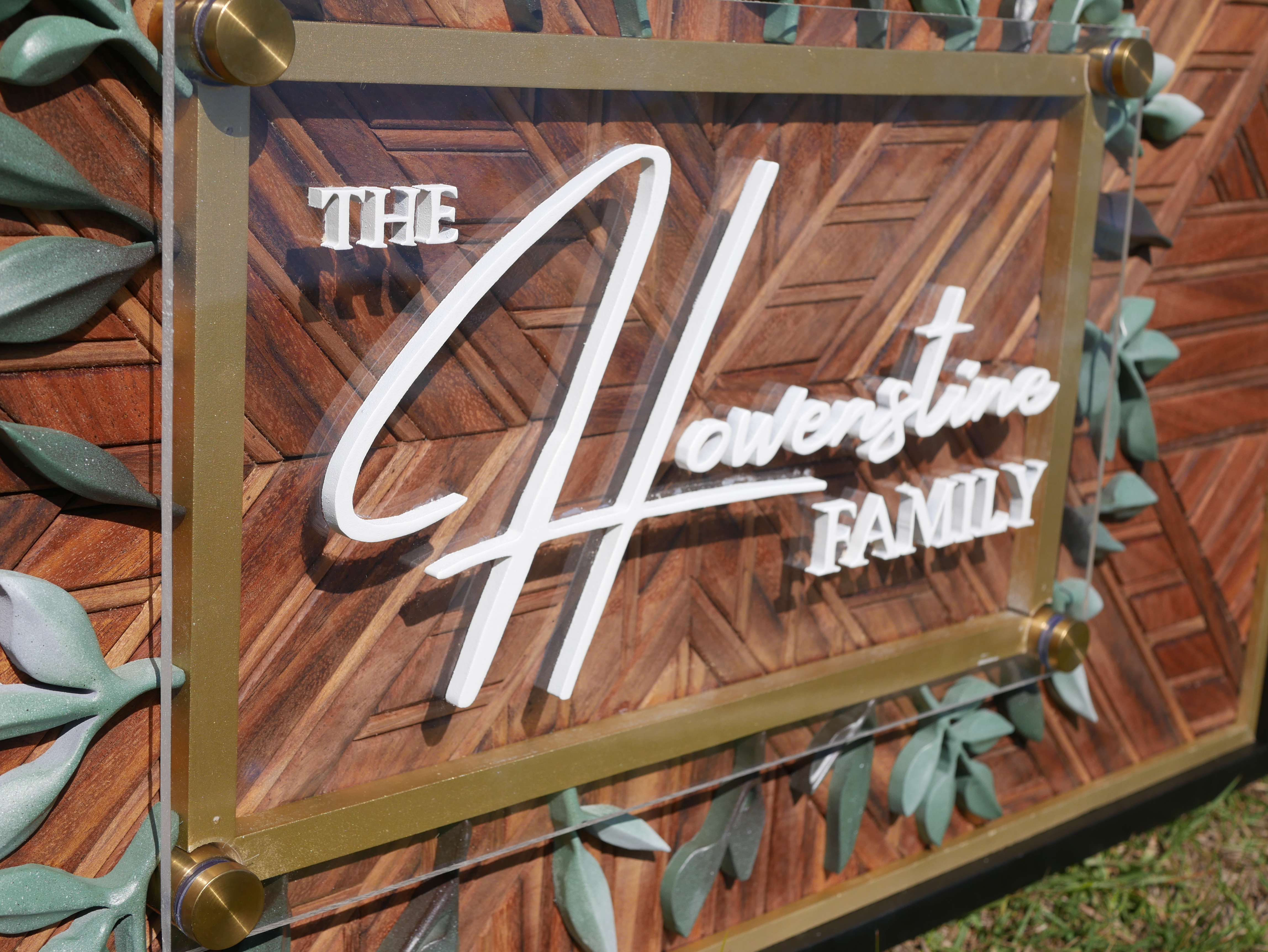 Custom Marra family name sign detail with acrylic overlay and wood mosaic background